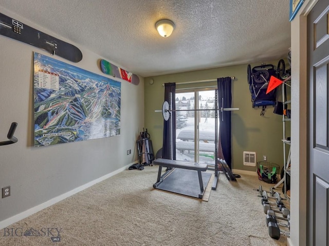 workout area with carpet flooring and a textured ceiling