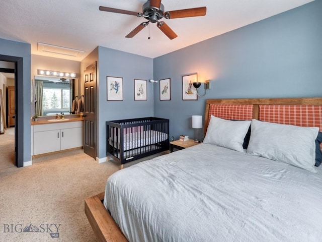 carpeted bedroom featuring ceiling fan, sink, and connected bathroom