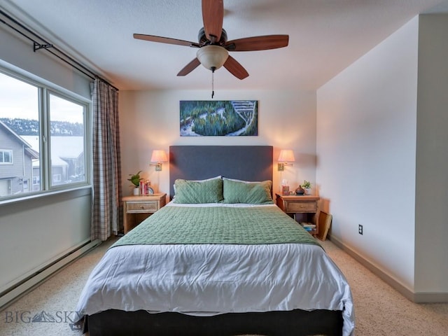 bedroom with ceiling fan and a baseboard radiator