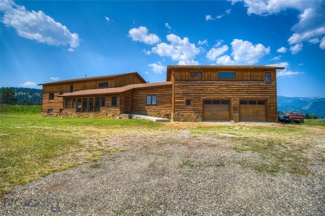 view of front of home featuring a mountain view and a garage