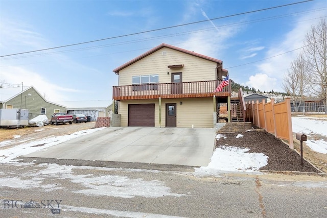 view of property with a garage and a deck