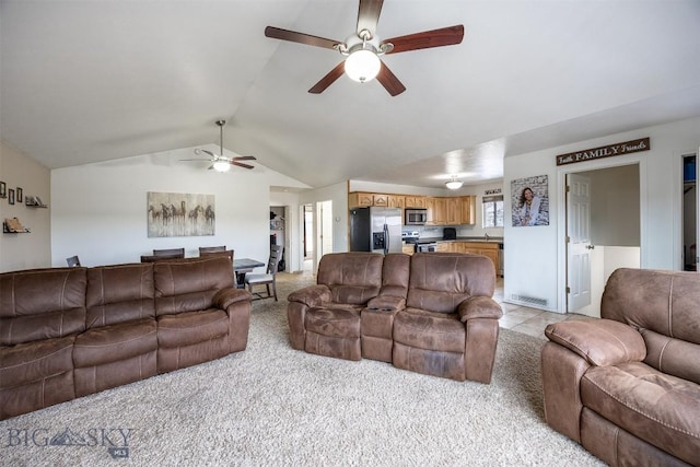 living room with light carpet, ceiling fan, and vaulted ceiling