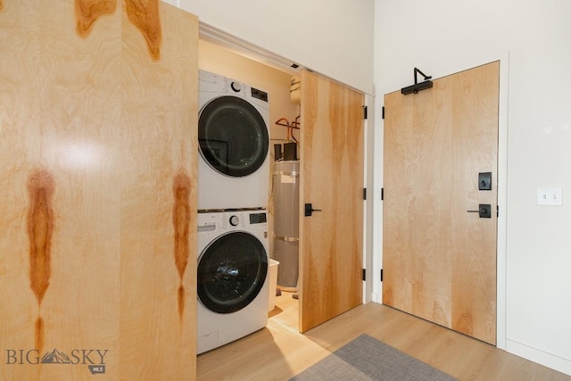 515 W Aspen St Unit 317, Bozeman, MT 59715 - laundry room featuring secured water heater, stacked washer / drying machine, wood finished floors, and laundry area