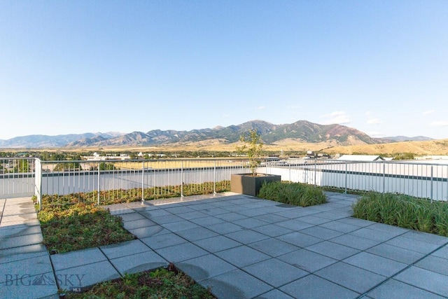 view of patio featuring a water and mountain view