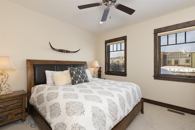 bedroom with light colored carpet and ceiling fan