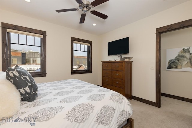 bedroom with light carpet and ceiling fan