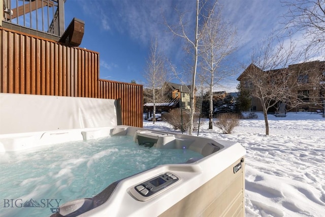 snow covered pool featuring a hot tub