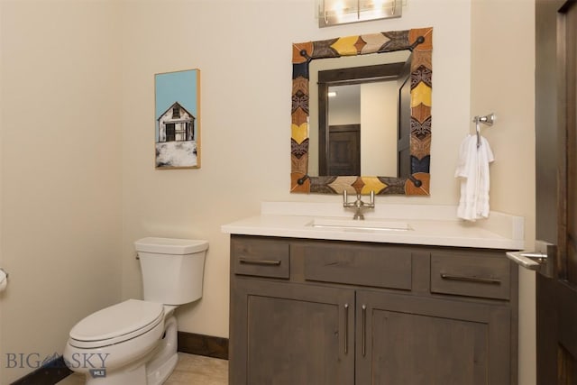 bathroom with tile patterned floors, vanity, and toilet