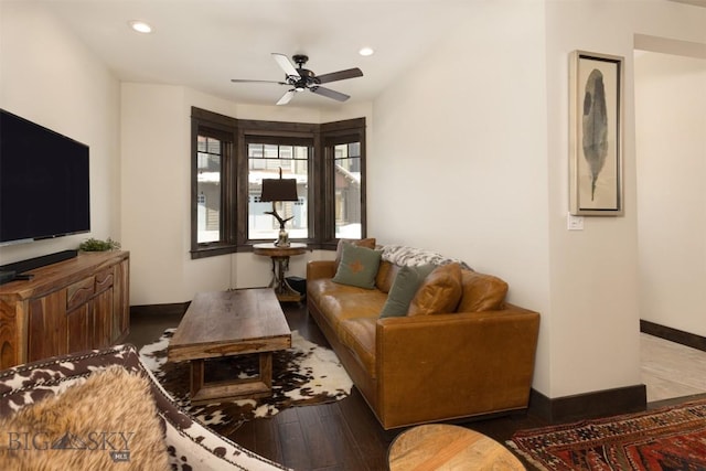 living room with ceiling fan and dark hardwood / wood-style flooring