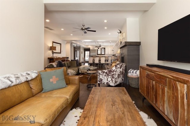 living room featuring ceiling fan and dark hardwood / wood-style floors