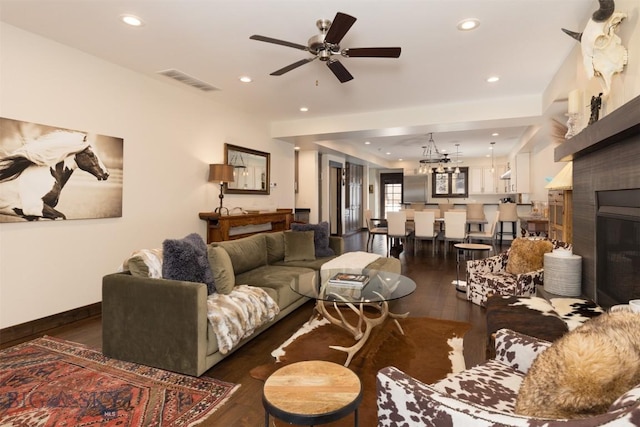 living room featuring dark hardwood / wood-style floors and ceiling fan