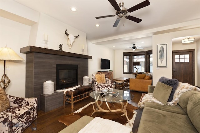 living room with ceiling fan and hardwood / wood-style floors