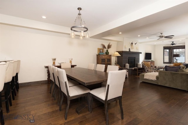 dining space with dark hardwood / wood-style flooring and ceiling fan