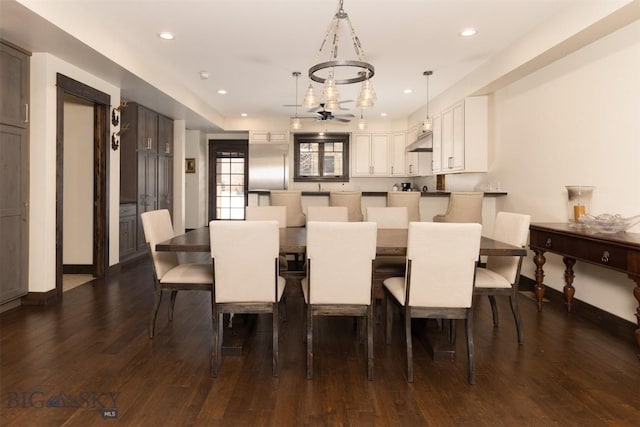 dining area with ceiling fan and dark hardwood / wood-style floors