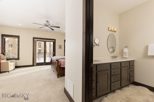 bathroom with ceiling fan and vanity