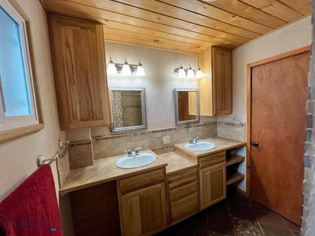 bathroom featuring decorative backsplash, wooden ceiling, and vanity