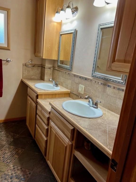 bathroom with vanity and backsplash