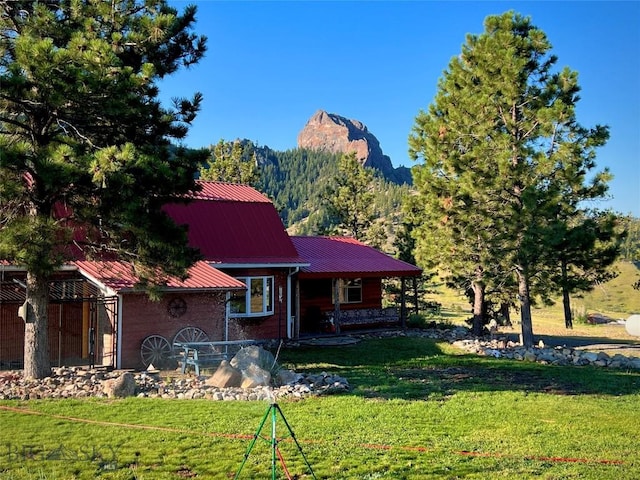 view of front of property with a mountain view and a front lawn