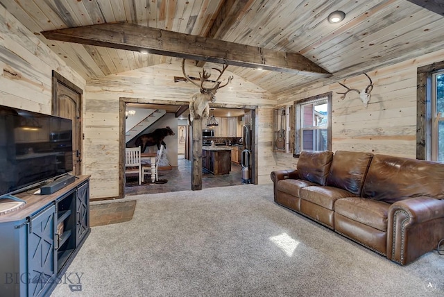 living room featuring vaulted ceiling with beams, wood walls, wooden ceiling, and carpet floors