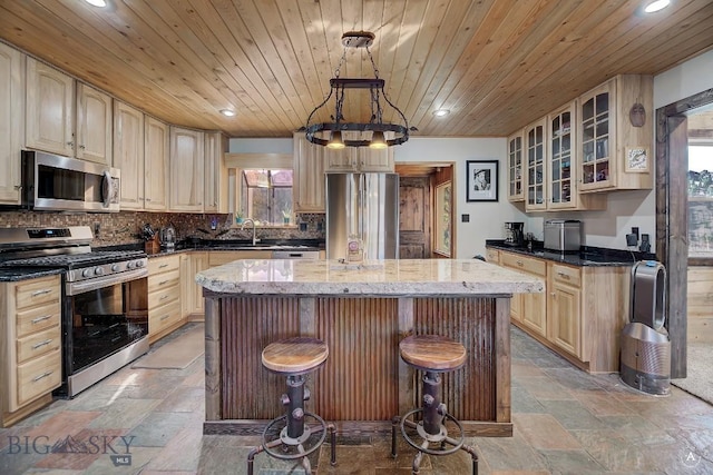 kitchen with wood ceiling, light stone counters, a center island, and stainless steel appliances