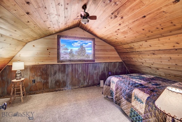 unfurnished bedroom with wood walls, carpet floors, wooden ceiling, and vaulted ceiling