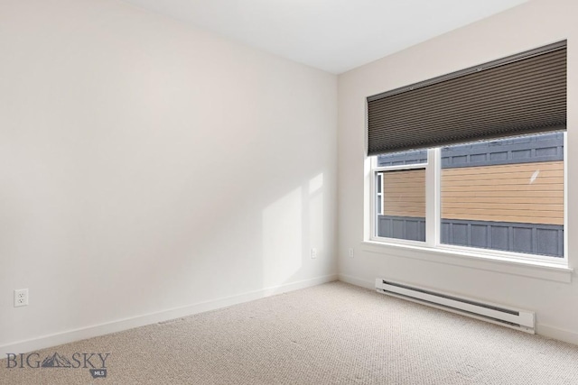 spare room with carpet, a baseboard radiator, and baseboards