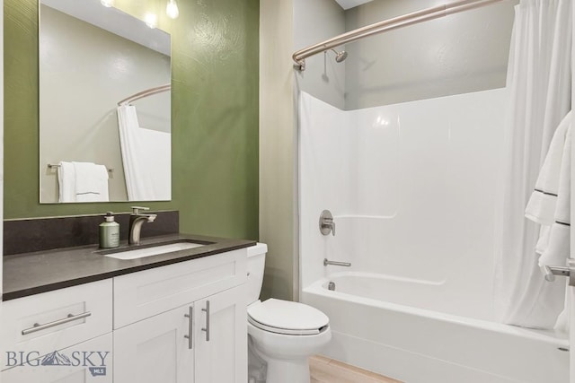 bathroom featuring toilet, shower / bath combination with curtain, and vanity