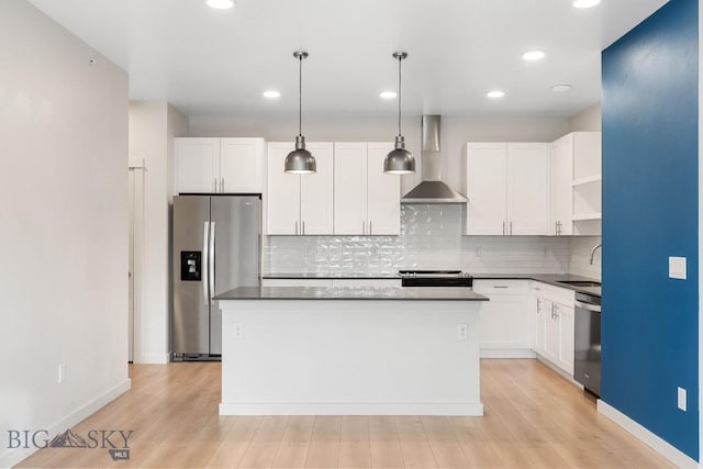 kitchen with open shelves, stainless steel appliances, a kitchen island, a sink, and wall chimney exhaust hood