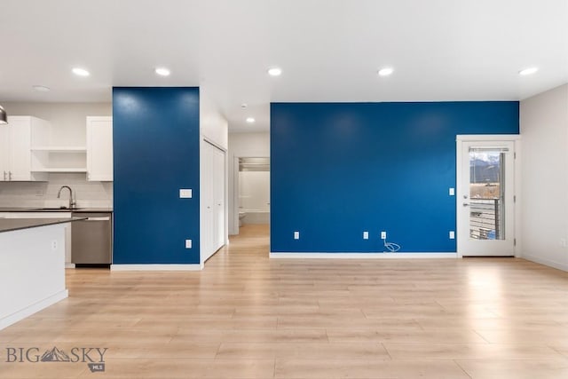 kitchen featuring white cabinets, backsplash, dishwasher, open shelves, and dark countertops