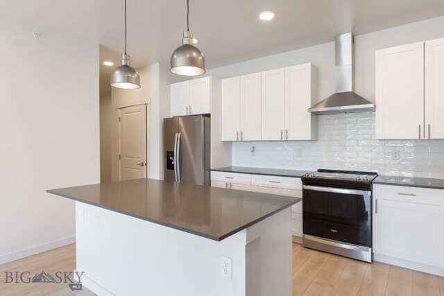 2221F Willow Unit 104, Livingston, MT 59047 - kitchen with stainless steel appliances, wall chimney exhaust hood, dark countertops, backsplash, and recessed lighting
