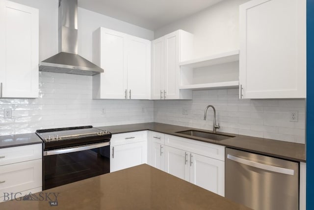 2221F Willow Unit 104, Livingston, MT 59047 - kitchen featuring appliances with stainless steel finishes, wall chimney range hood, a sink, and dark countertops