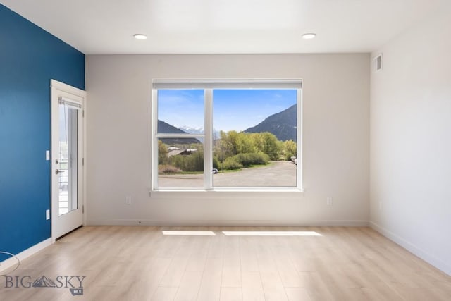 2221F Willow Unit 104, Livingston, MT 59047 - unfurnished room featuring a mountain view, light wood-style floors, baseboards, and recessed lighting