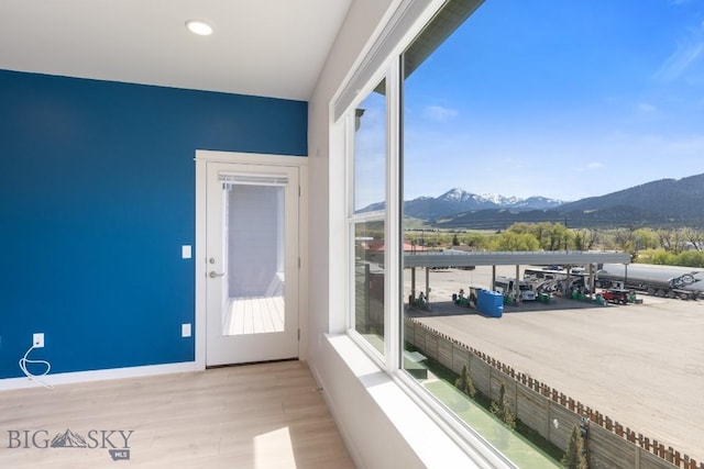 2221F Willow Unit 104, Livingston, MT 59047 - doorway featuring a mountain view, light wood-type flooring, and baseboards