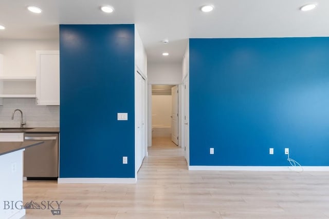 2221F Willow Unit 104, Livingston, MT 59047 - kitchen with stainless steel dishwasher, dark countertops, a sink, light wood finished floors, and recessed lighting