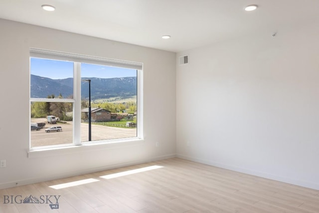 2221F Willow Unit 104, Livingston, MT 59047 - empty room featuring a mountain view, light wood finished floors, baseboards, and recessed lighting