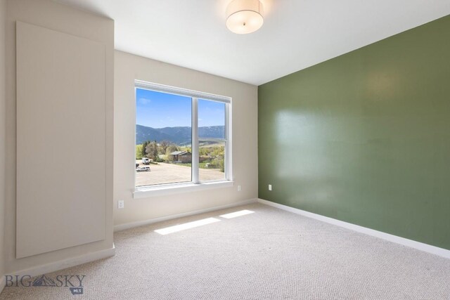 2221F Willow Unit 104, Livingston, MT 59047 - carpeted spare room featuring a mountain view and baseboards