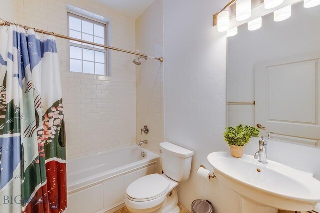 full bathroom with toilet, sink, and shower / tub combo