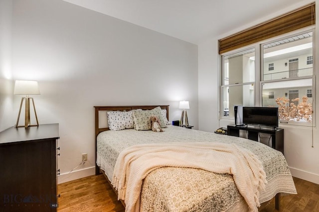 bedroom with dark wood-type flooring