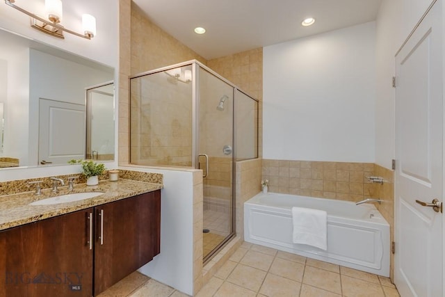 bathroom featuring vanity, tile patterned flooring, and plus walk in shower