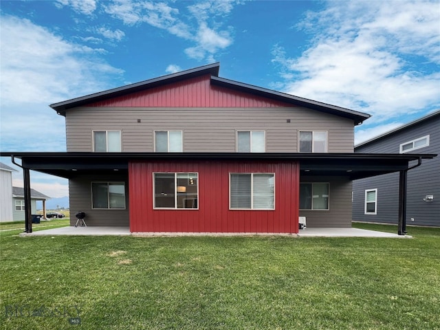 back of property featuring a lawn and a patio area