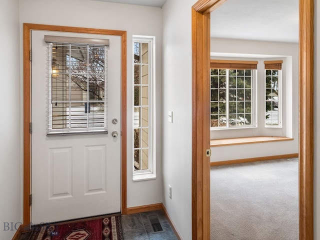 doorway to outside with carpet