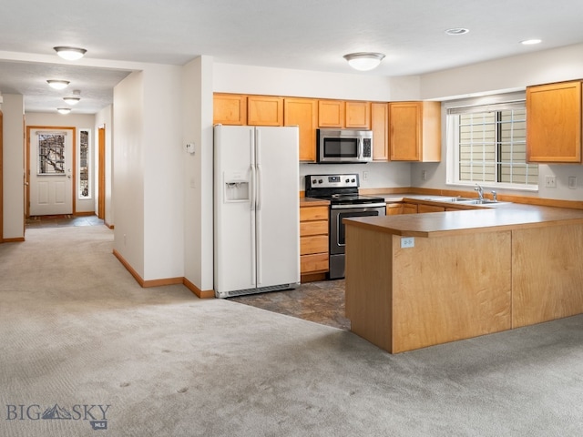 kitchen featuring kitchen peninsula, plenty of natural light, dark carpet, and appliances with stainless steel finishes