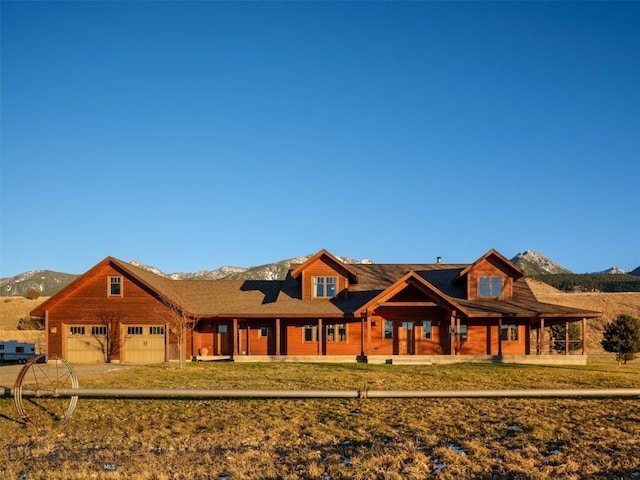 view of front facade with an attached garage and a mountain view