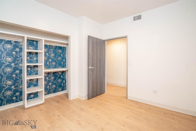 unfurnished room with hardwood / wood-style flooring