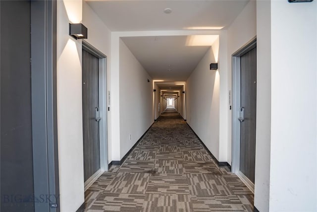 hallway featuring dark carpet