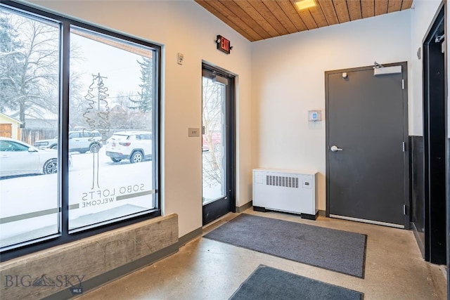 doorway with radiator and wood ceiling