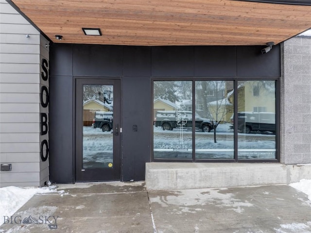 view of snow covered property entrance