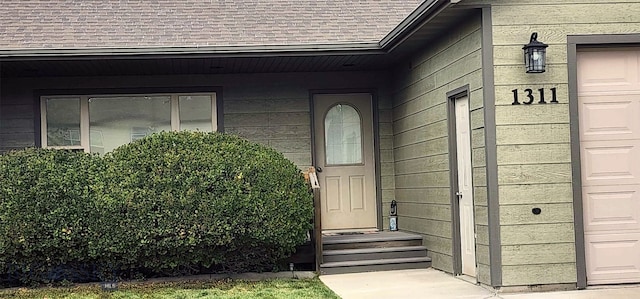 view of exterior entry featuring a garage