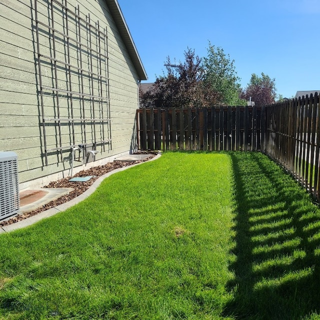 view of yard with central air condition unit