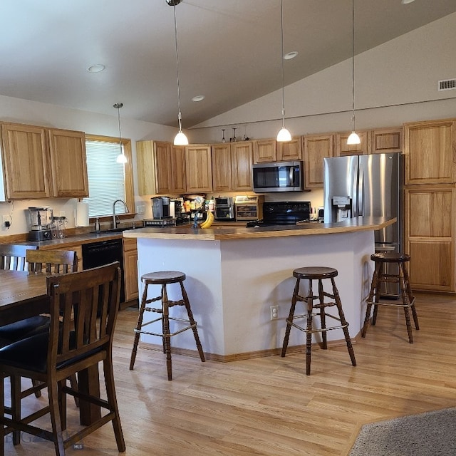 kitchen featuring decorative light fixtures, butcher block countertops, lofted ceiling, and black appliances